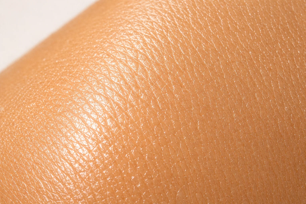 Close-up of glowing, even skin tone representing the effects of glutathione on melanin and cellular health